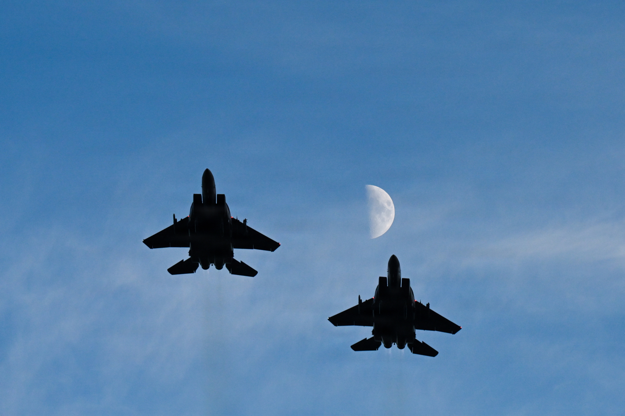 F15 fighter jets in the sky with moonrise