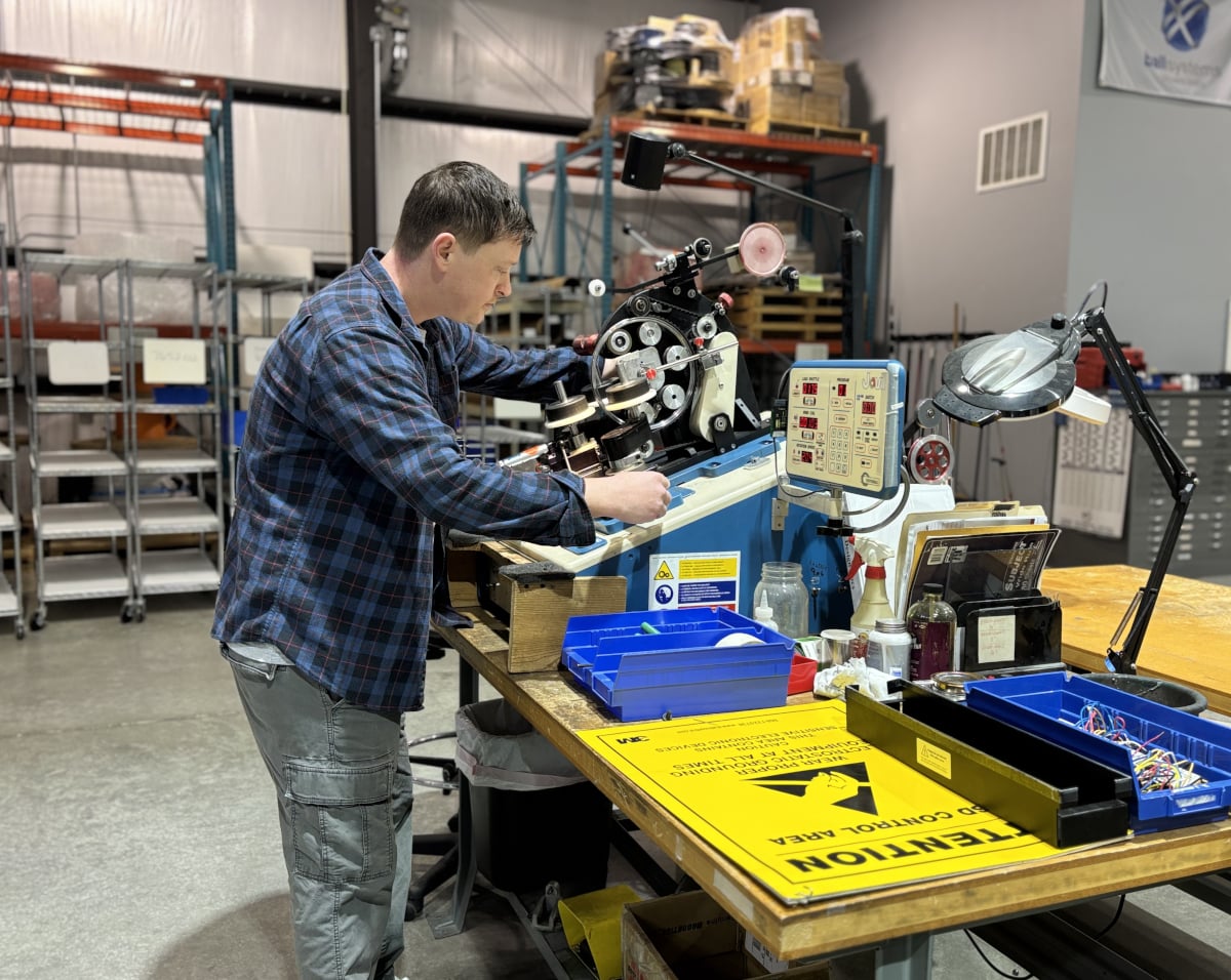 Engineer working on a jovi machine for aerospace defense applications